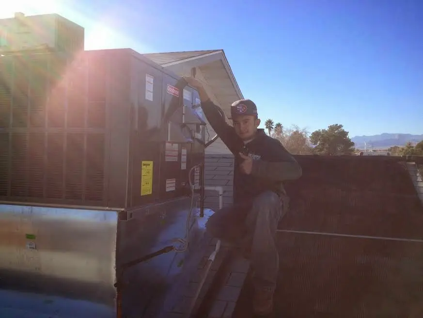 HVAC technician performing HVAC Inspection on a rooftop unit in Lavon